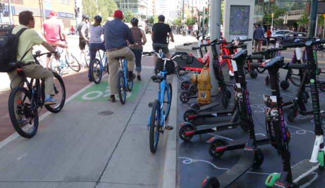 A mix of scooters, bikes, and bikeshare bikes on Denver bikeway