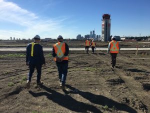 Engineers walking a redevelopment site in Edmonton, Alberta