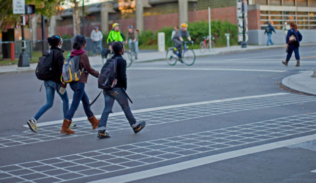 Girls crossing the street in an urban setting
