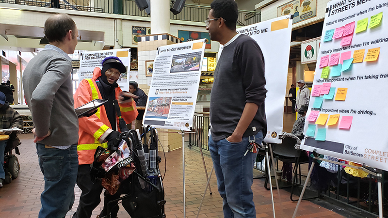 Toole Design staff conducts public outreach with a man in a reflective jacket