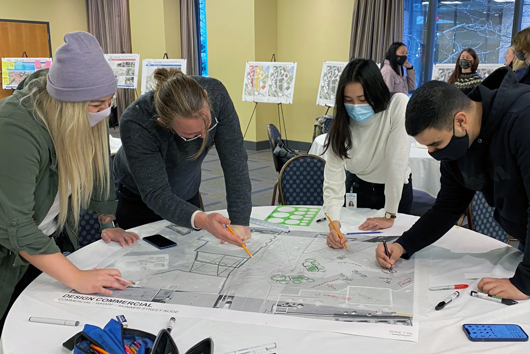 Nanaimo residents make notes on a map of the downtown area during the discovery charrette.