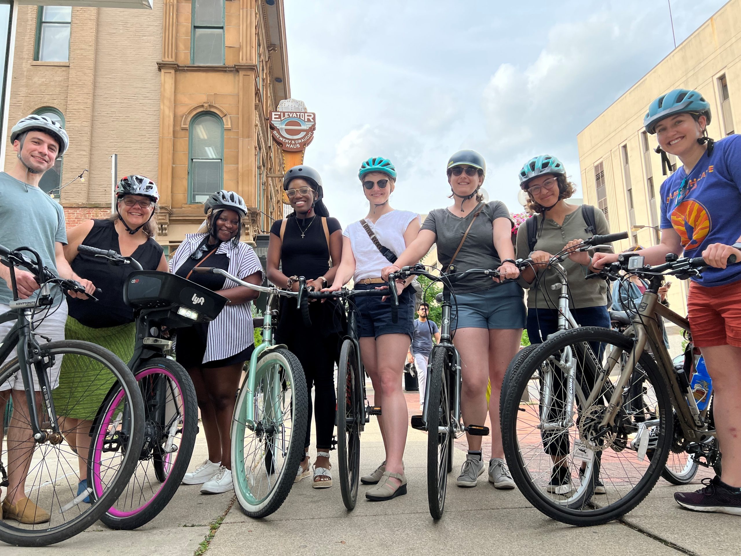 Staff members from the Columbus office stand next to each other and their bikes.