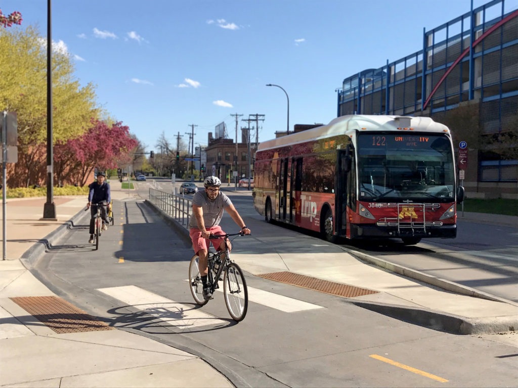 People riding bicycles on a U of Minnesota protected bikeway