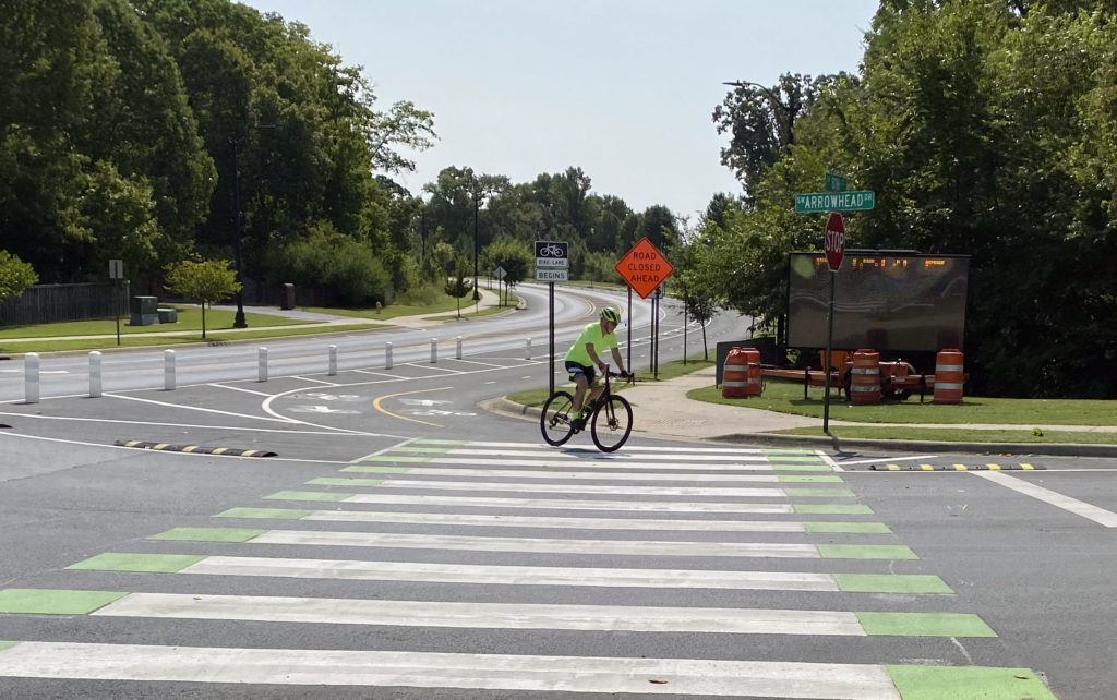 Man rides bike around corner on 2 way bike lane