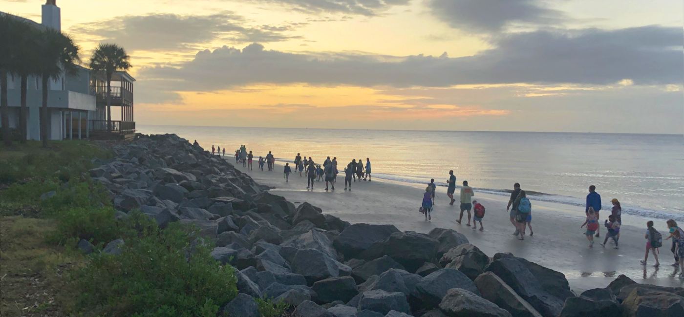 Families walk along the beach during sunrise during a Walk the Beach to School event on St. Simons, Georgia, as part of the local Safe Routes to School initiatives.