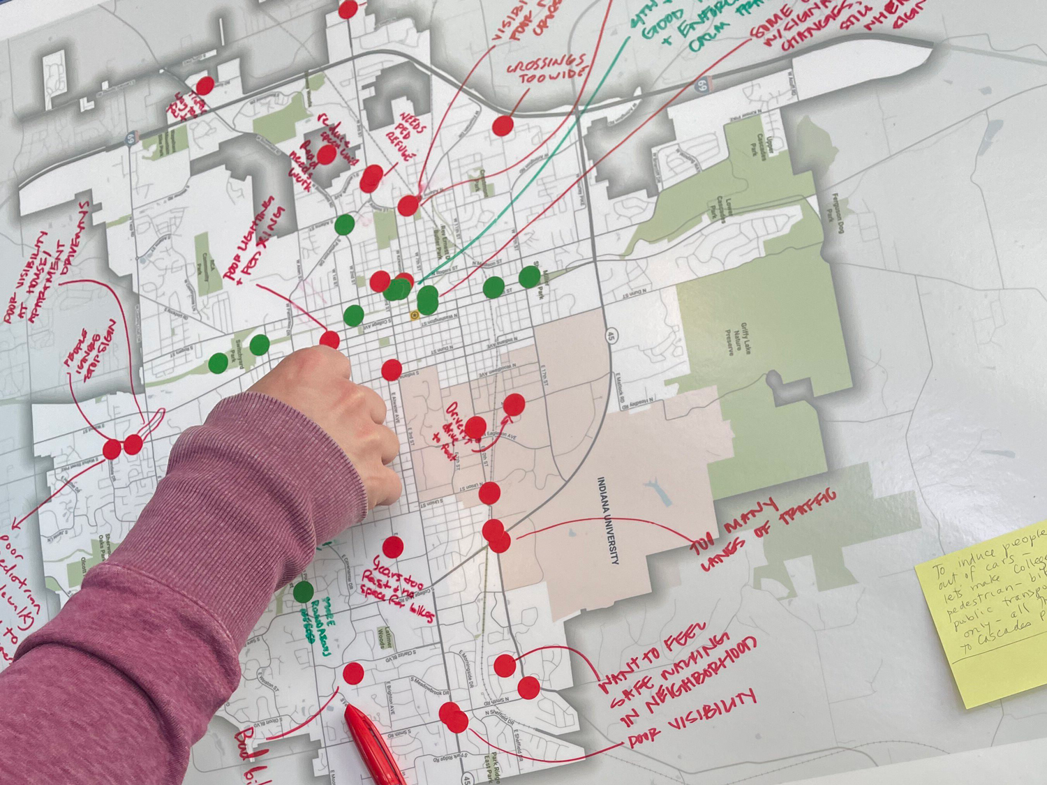 A resident's hand adding to a map identifying safety concerns and potential future projects as part of the Bloomington SS4A Safety Week event