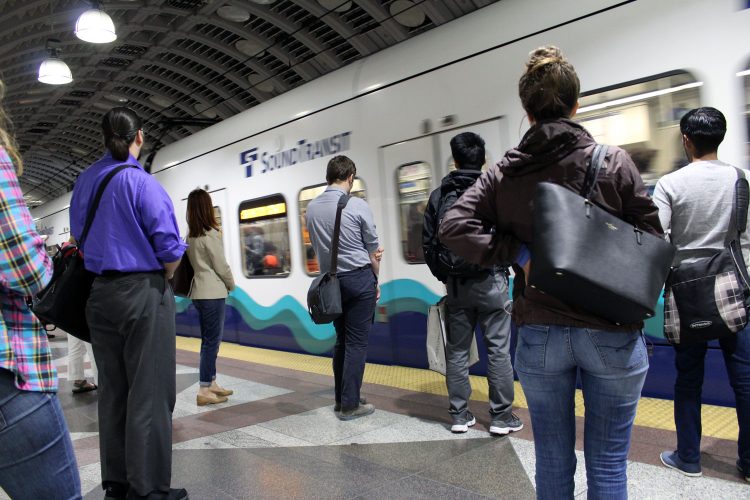 A group of people wait for the subway.